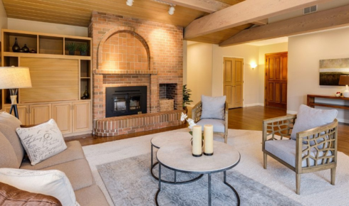 How can adding a single statement light fixture change the atmosphere of a plain room