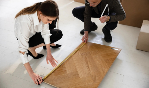 How can planning expansion gaps in wooden floors prevent future buckling