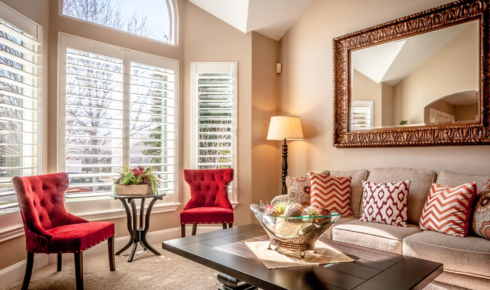 How can using mirrors opposite windows bring more light into darker rooms