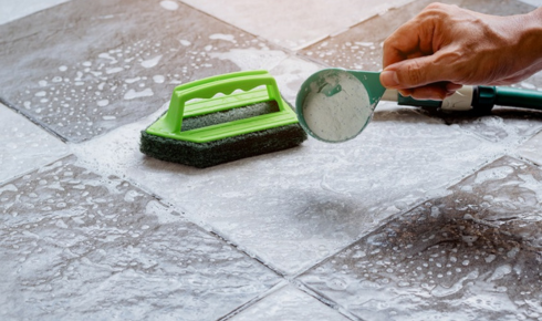 Why might a slightly textured floor be safer than a completely smooth one in wet areas